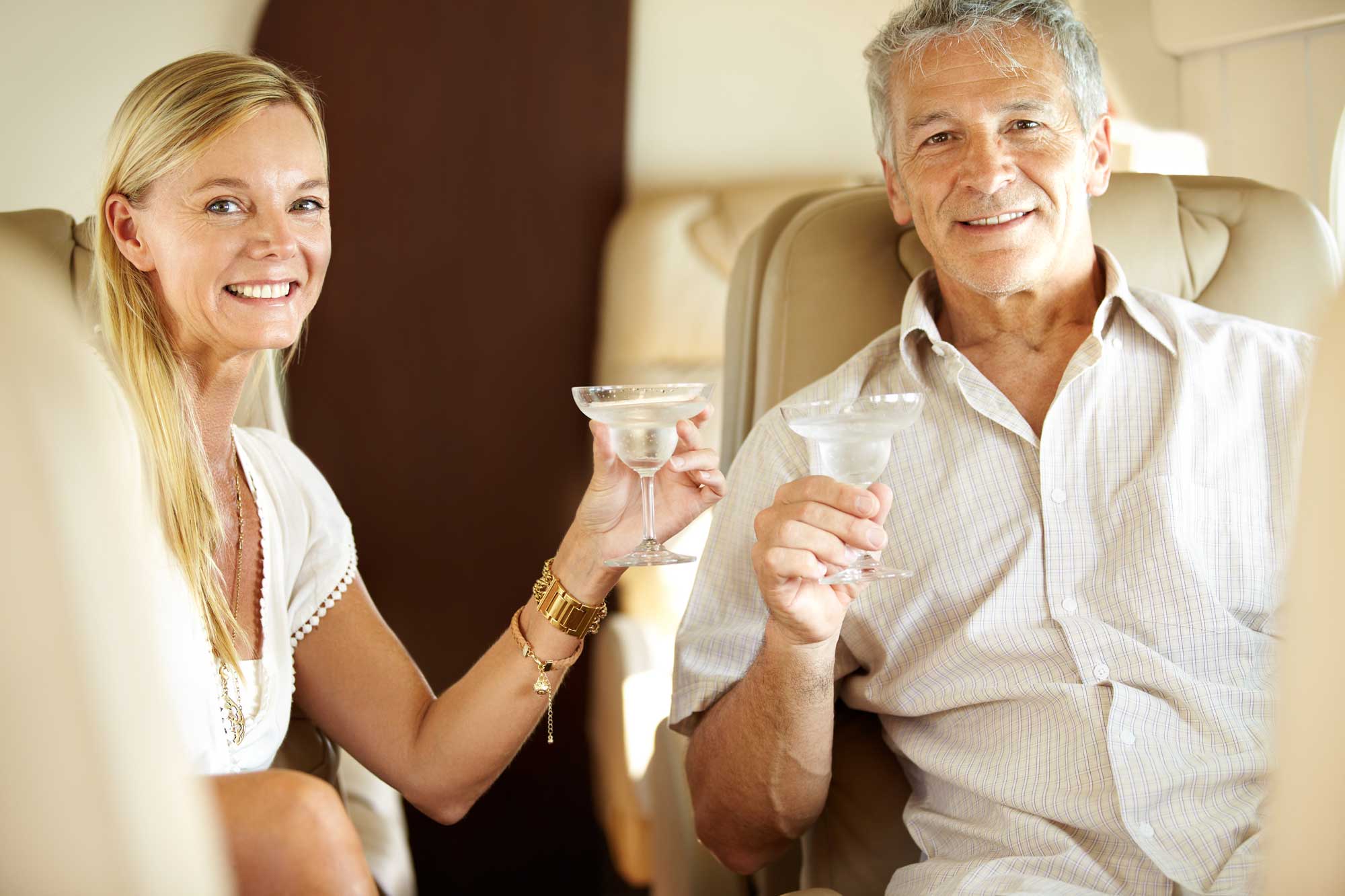 portrait-happy-couple-and-champagne-in-private-jet-on-holiday-vacation-and-travel